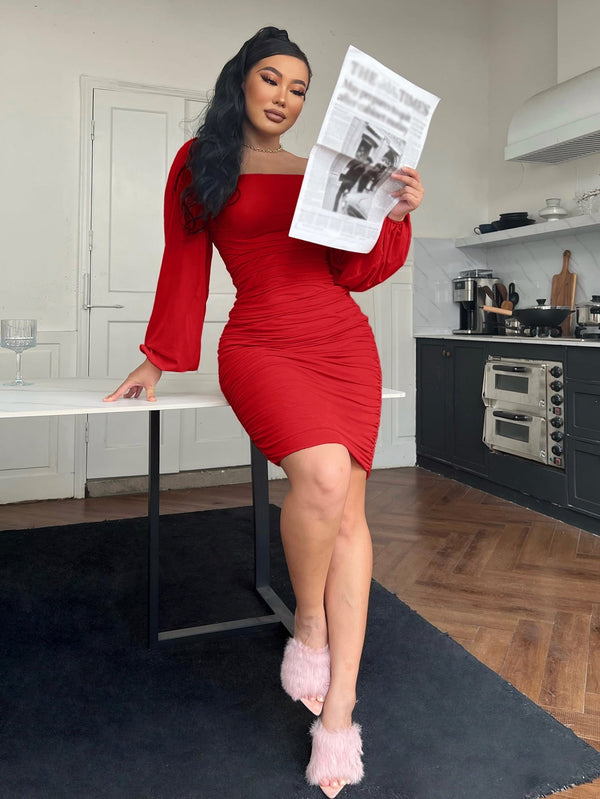 Knee-length red zip-back ruched bodycon dress with long sleeves and square neckline.