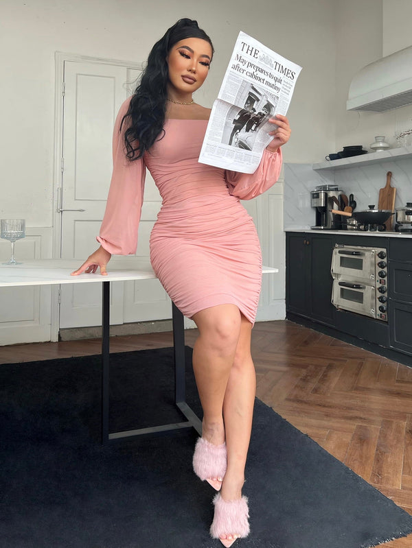 Chic pink zip-back ruched bodycon dress with square neck and long sleeves.