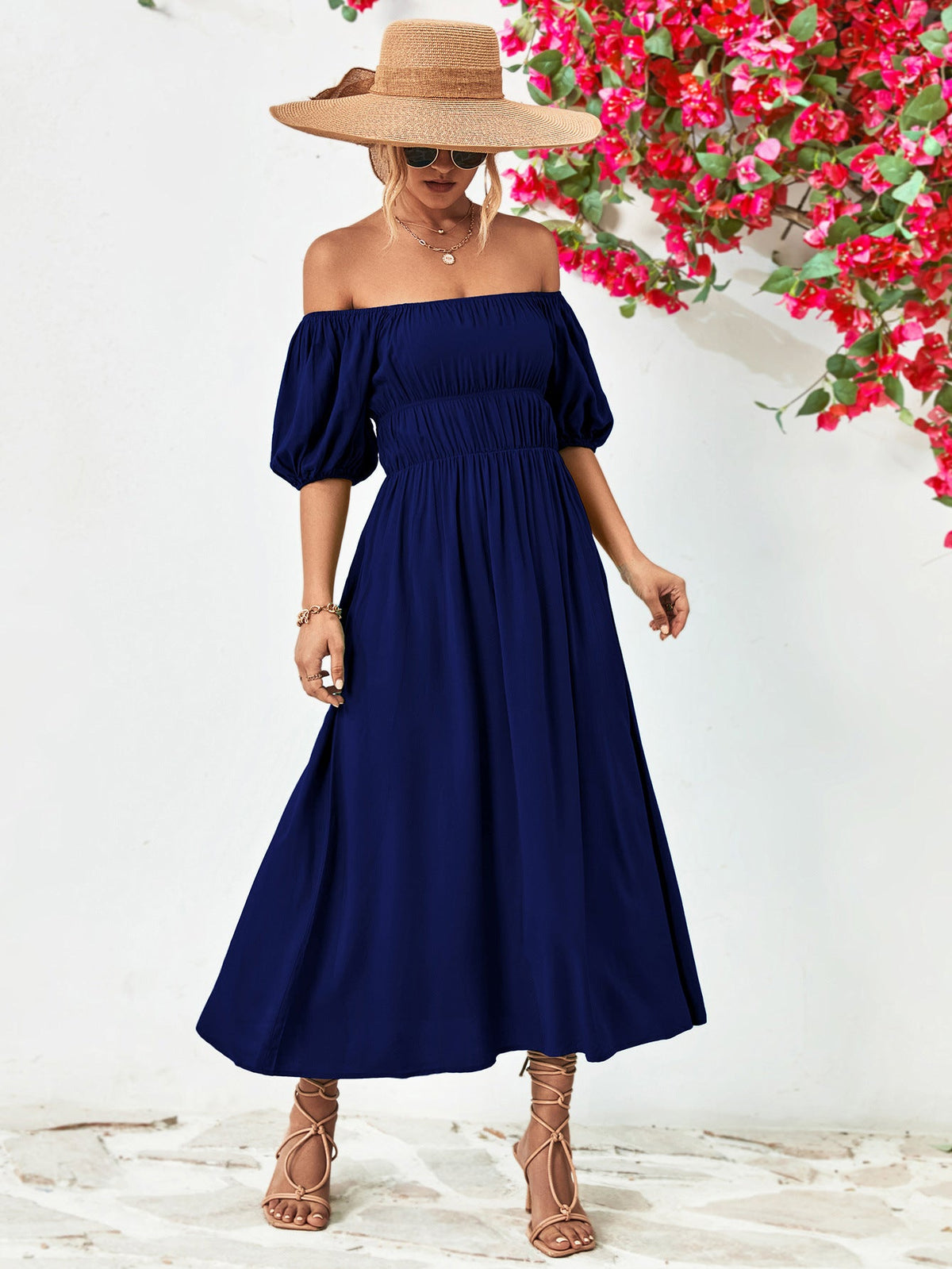Off-shoulder balloon sleeve midi dress in solid navy with A-line hem.