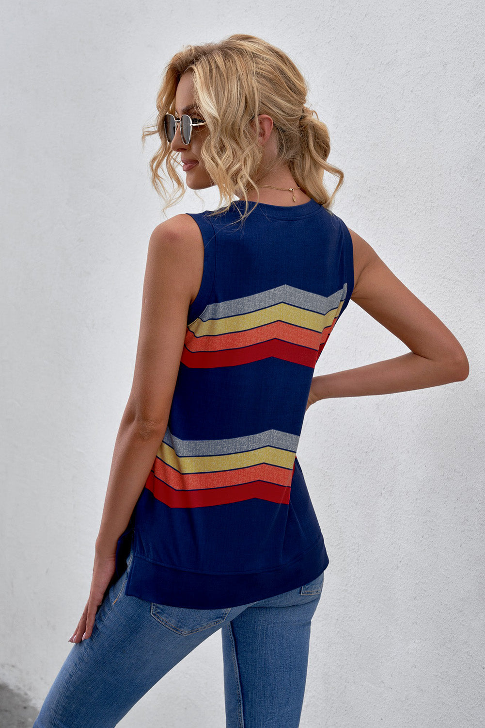 Sleeveless printed tank with side slit and round neck, featuring colorful stripes.