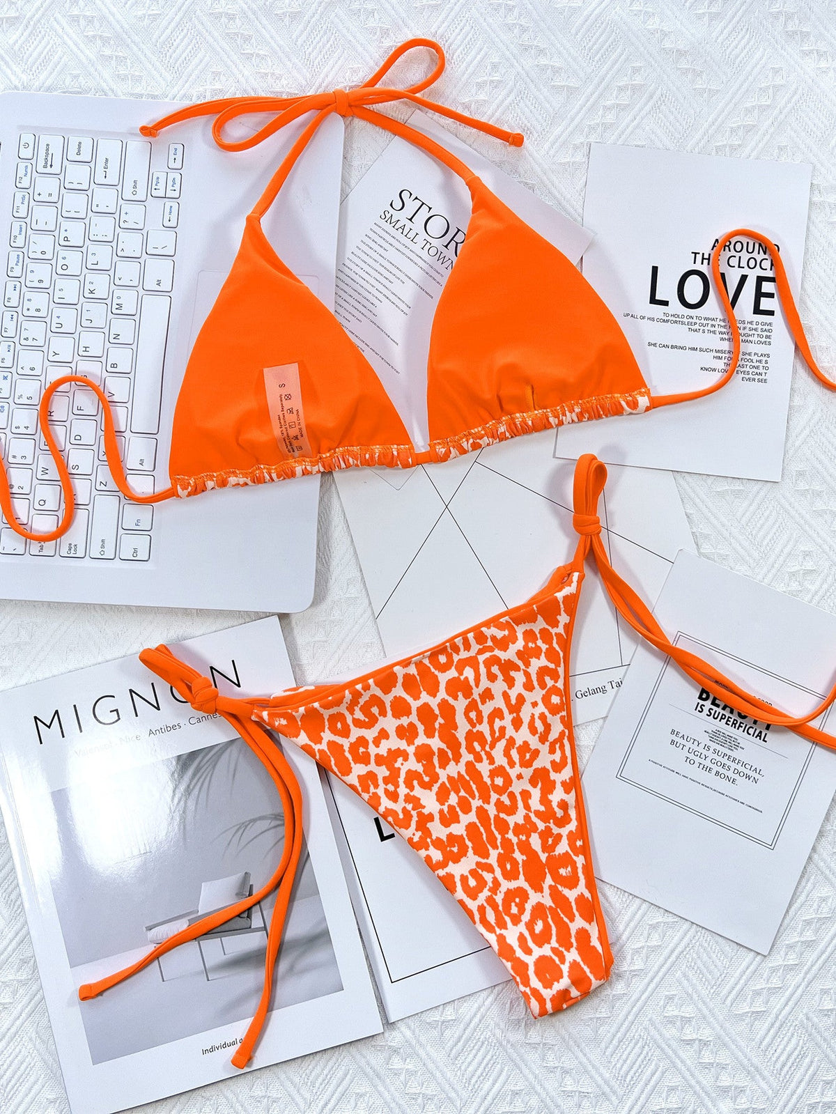 Leopard print halter neck tie side bikini set featuring orange and white pattern.