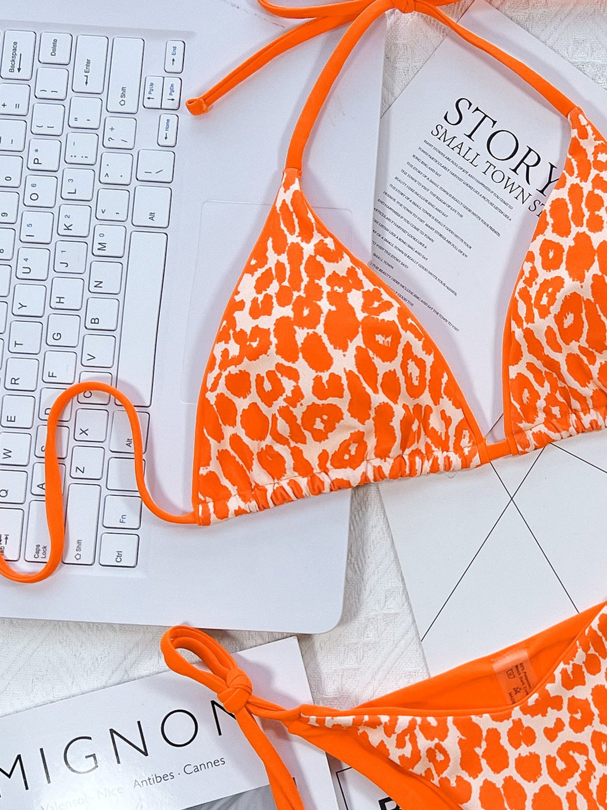 Leopard print halter neck tie side bikini set with removable padding.