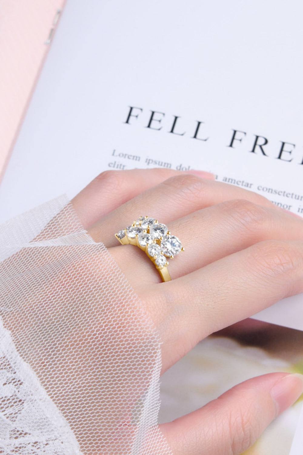 Moissanite ring in 925 sterling silver with platinum and 18K gold plating.